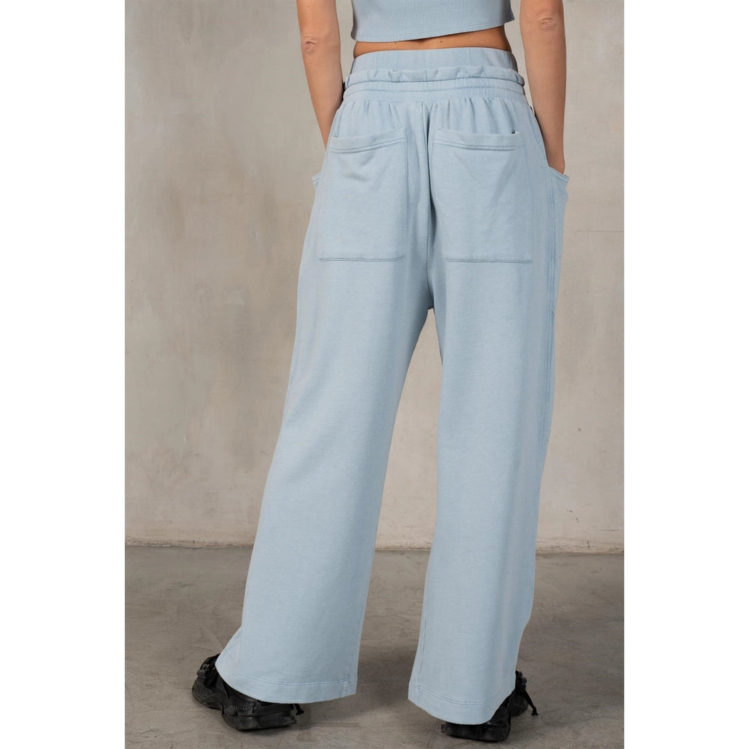 Light blue pants worn by a person against a neutral background