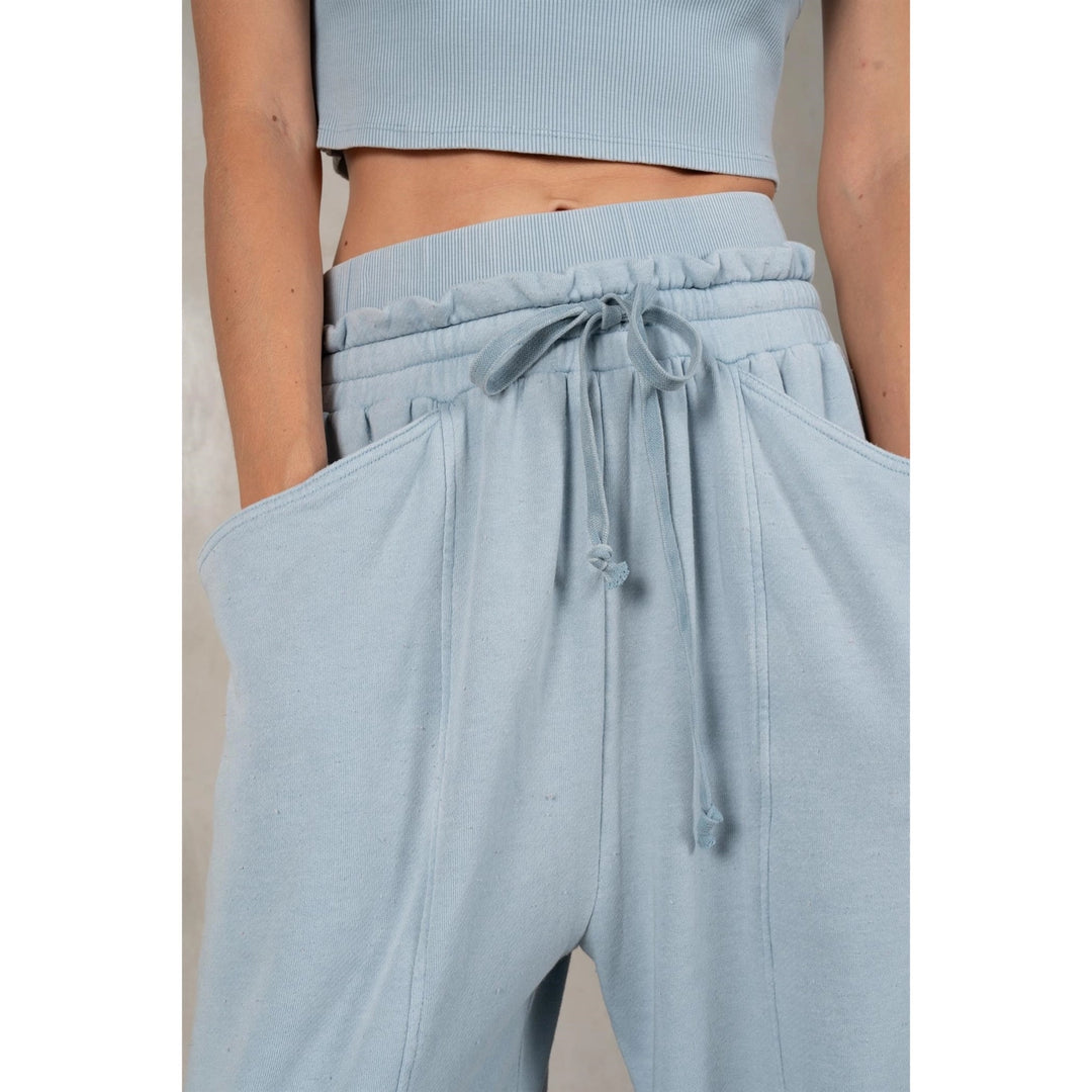 Light blue crop top and wide-leg pants on a plain background