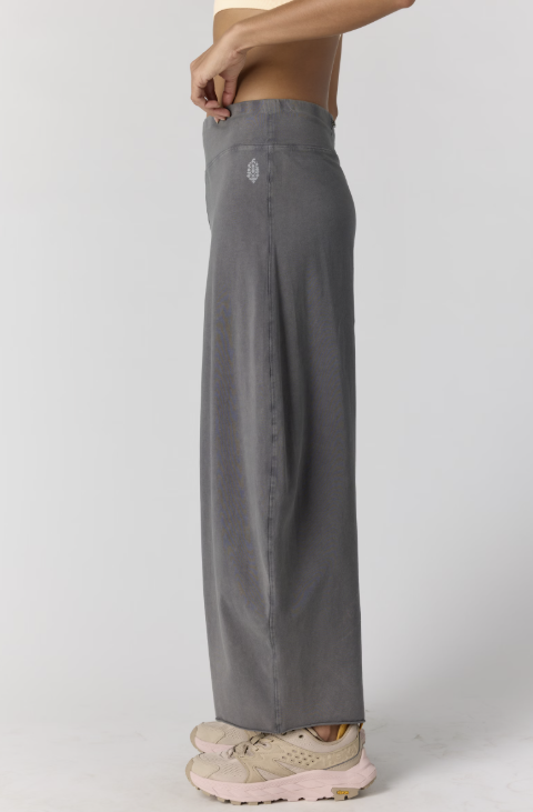 Woman wearing grey pants on plain background