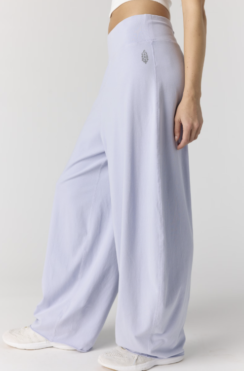 Woman wearing purple pants on plain background