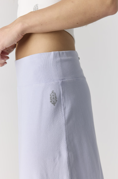 Close up of purple pants with logo on plain background