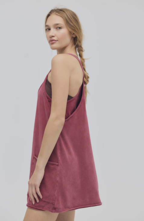 Woman wearing red mini dress on white background