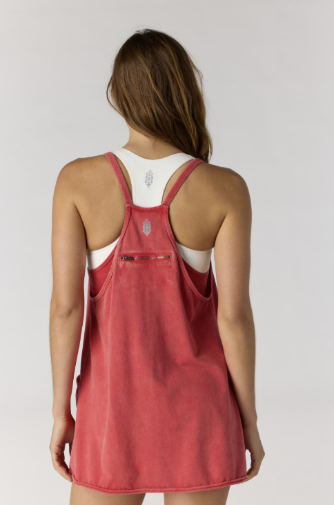 Woman shown from back wearing red mini dress on white background
