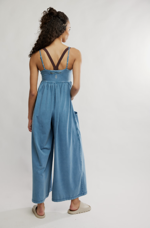 woman wearing blue onesie on plain background