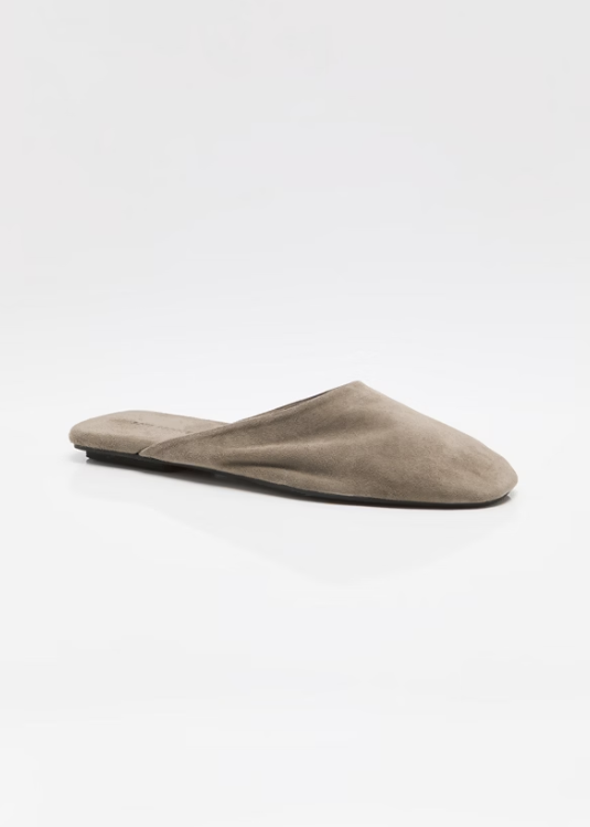 Single beige mule shoe on white background