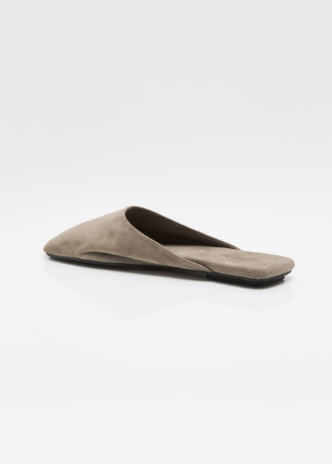Single beige mule shoe on white background