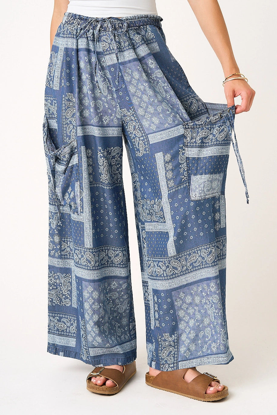 Blue patterned wide-leg pants worn by a person on a white background