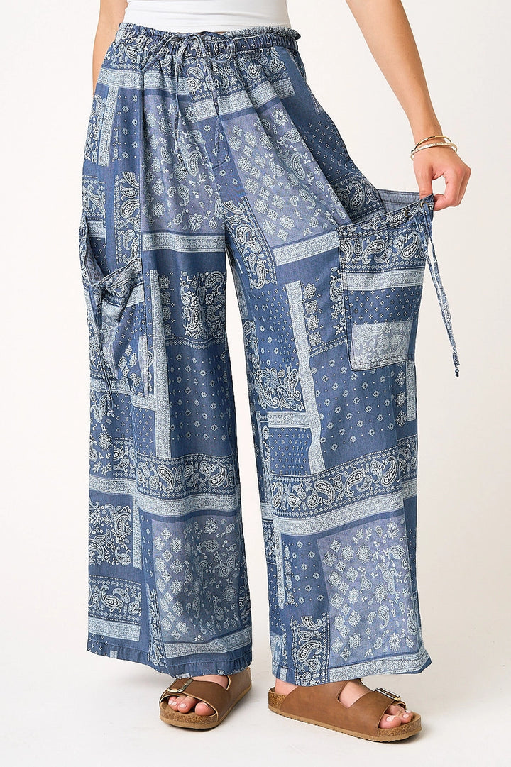 Blue patterned wide-leg pants worn by a person on a white background