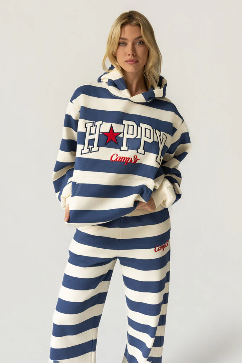 Person wearing a blue and white striped hoodie and pants with &