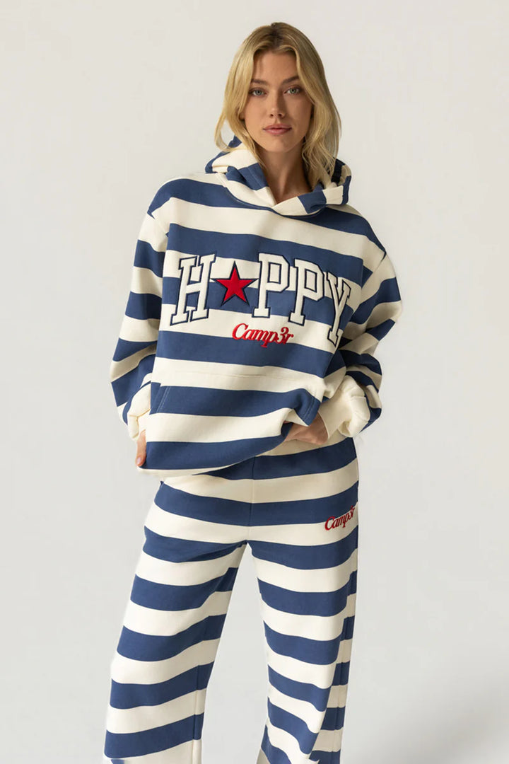 Person wearing a blue and white striped hoodie and pants with &