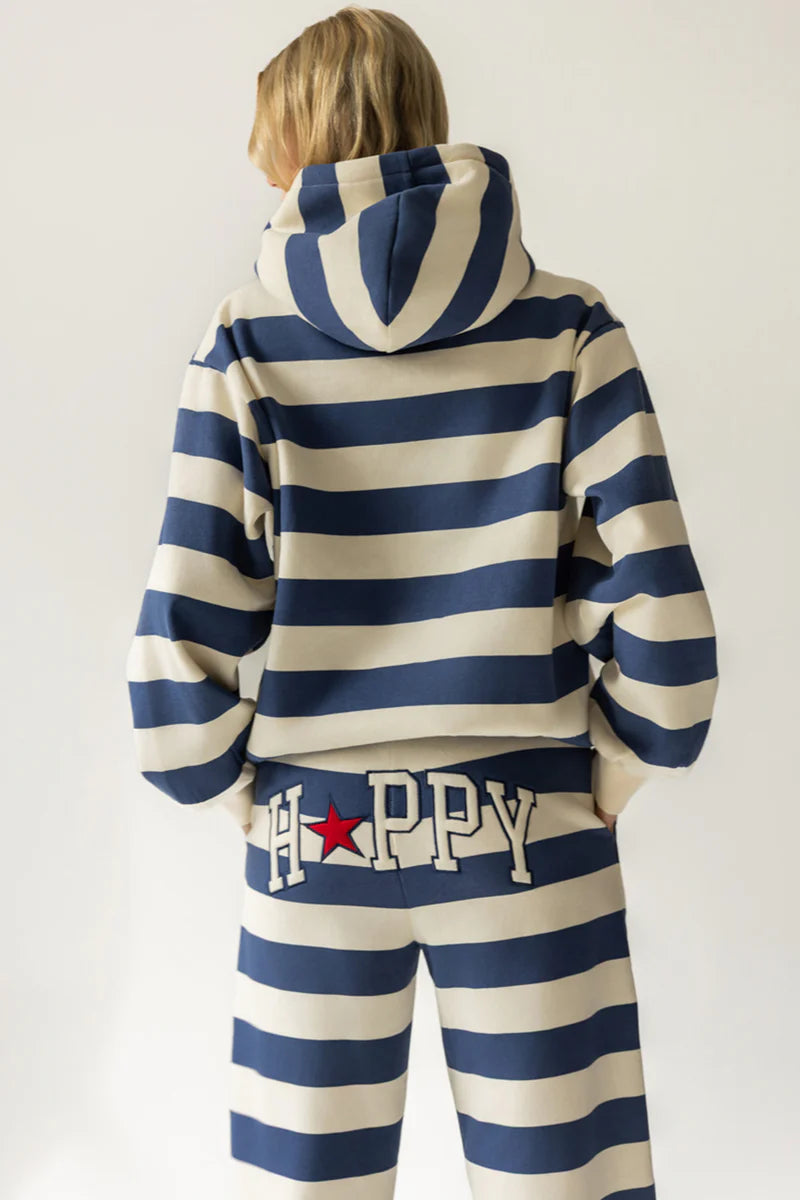 Person wearing a blue and white striped hoodie and pants with &
