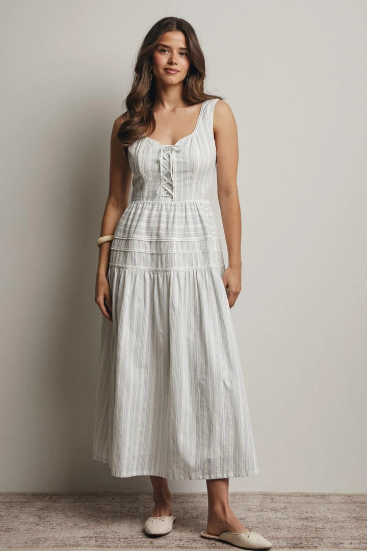Woman wearing a white dress against a plain background
