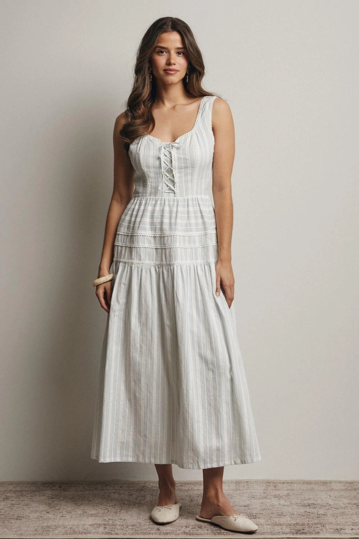 Woman wearing a white dress against a plain background