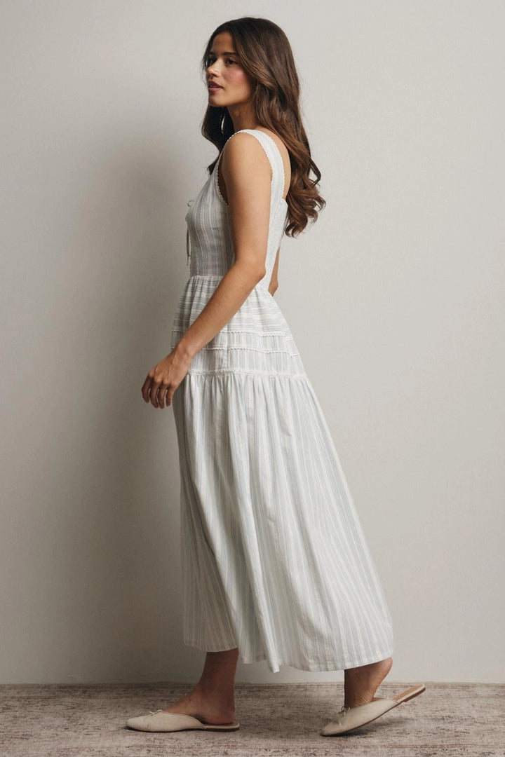 Woman wearing a white dress against a plain background