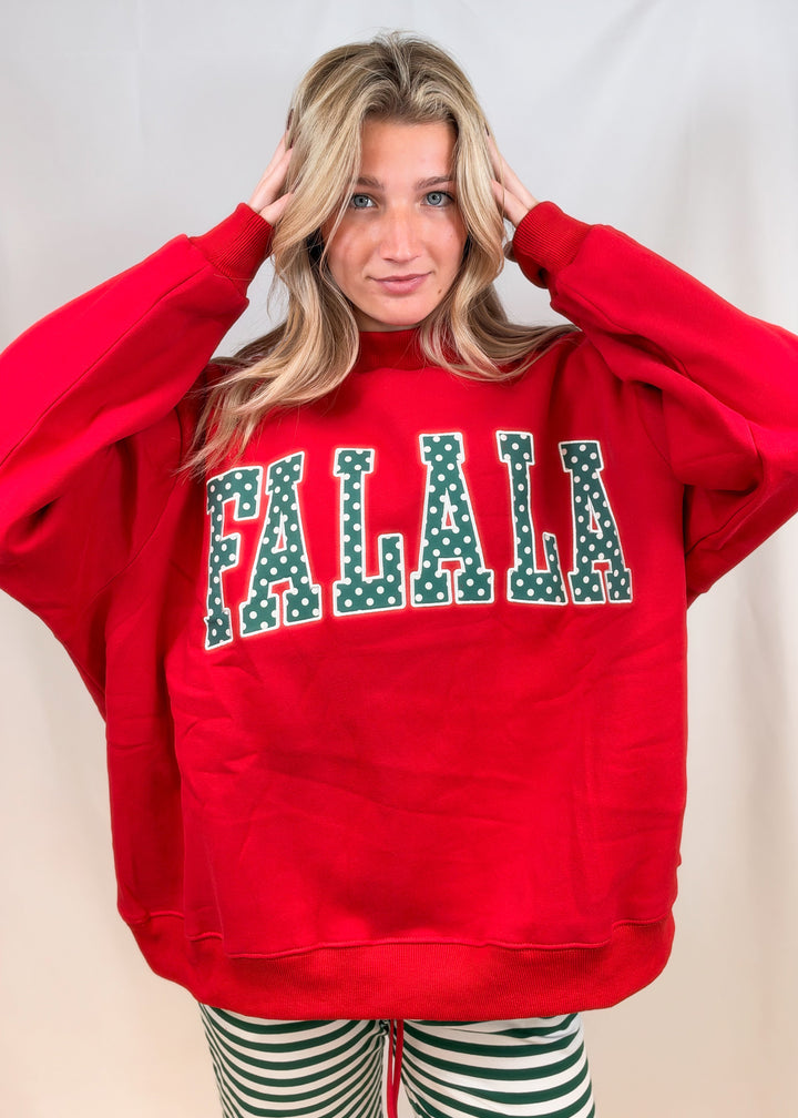 Woman wearing red mock neck sweatshirt with &