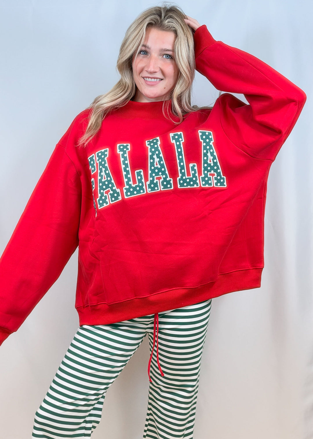 woman wearing red mock neck sweatshirt with &