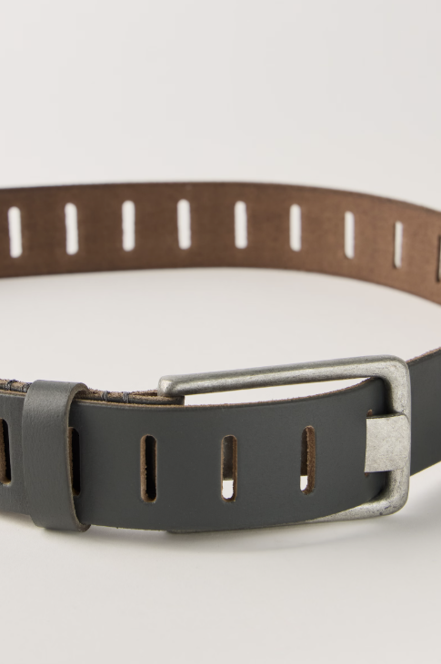 Dark grey slotted belt on beige background