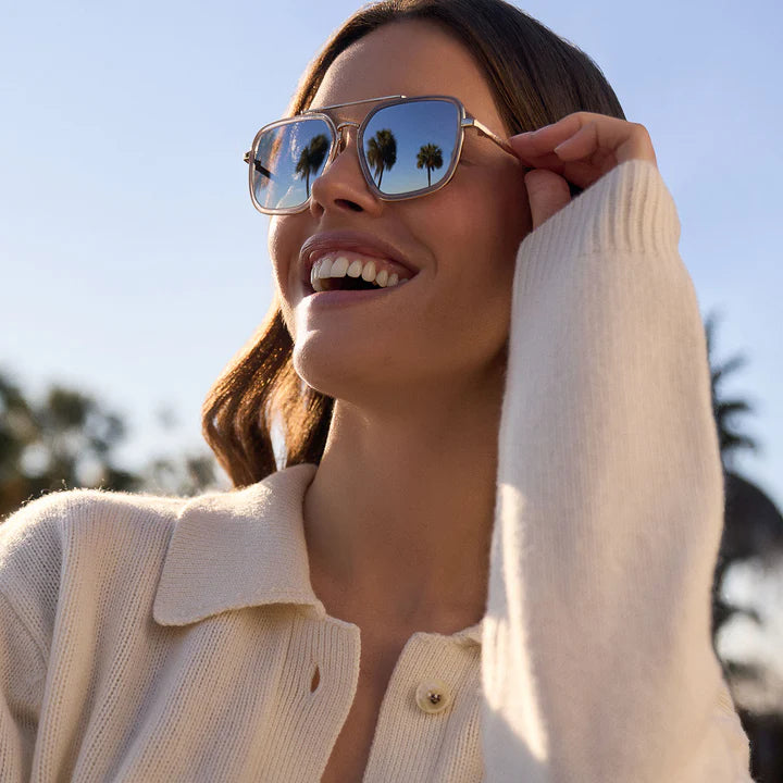 Woman wearing sunglasses with a blurred outdoor background