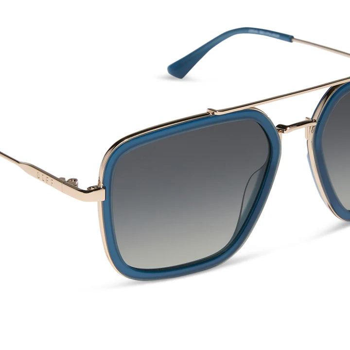 Sunglasses with blue frames and gradient lenses on a white background