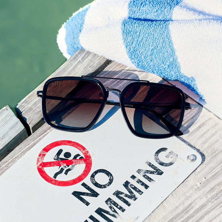 Black sunglasses with gradient lenses on dock