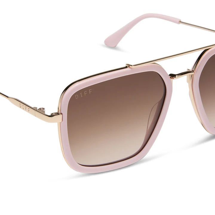 Sunglasses with pink frames and brown gradient lenses on a white background