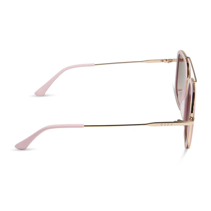 Side profile of a pair of round-frame sunglasses with light pink temples and gold metal frames on a white background.