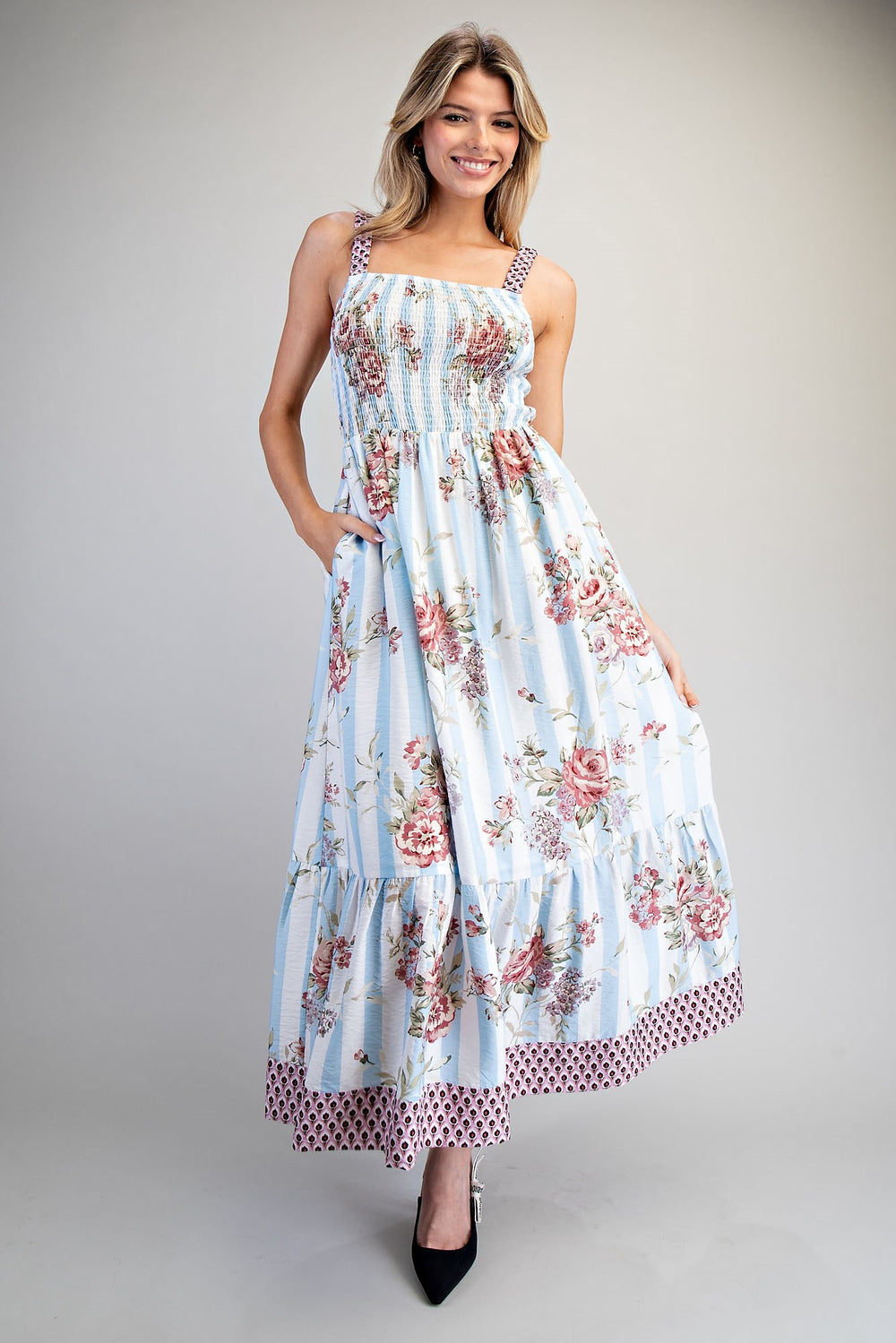 Woman wearing a floral dress on a plain background