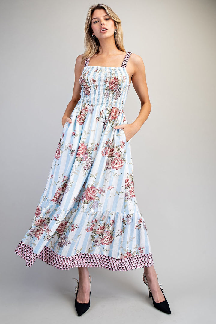 Woman wearing a floral dress with a light blue background