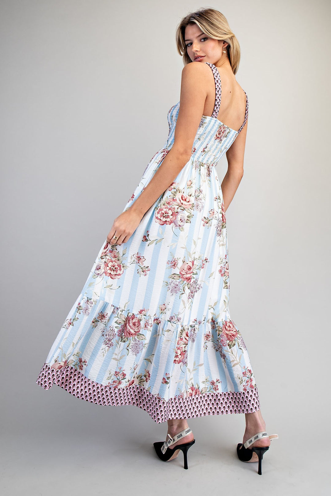 Woman wearing a floral dress with a white background