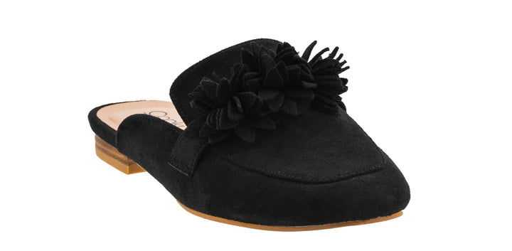 A black suede mule slipper with a large black fabric flower embellishment on the vamp, shown from a three-quarters angle against a plain white background.