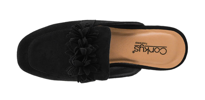 A single black suede mule slipper with a large fabric flower detail across the top, shown from a top-down view on a white background. The tan insole displays the brand name Corkus.