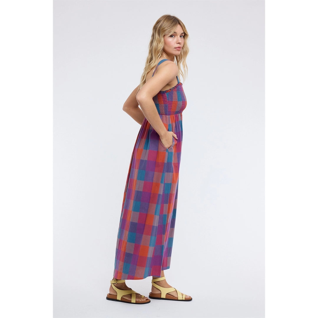 Woman wearing plaid dress on plain background