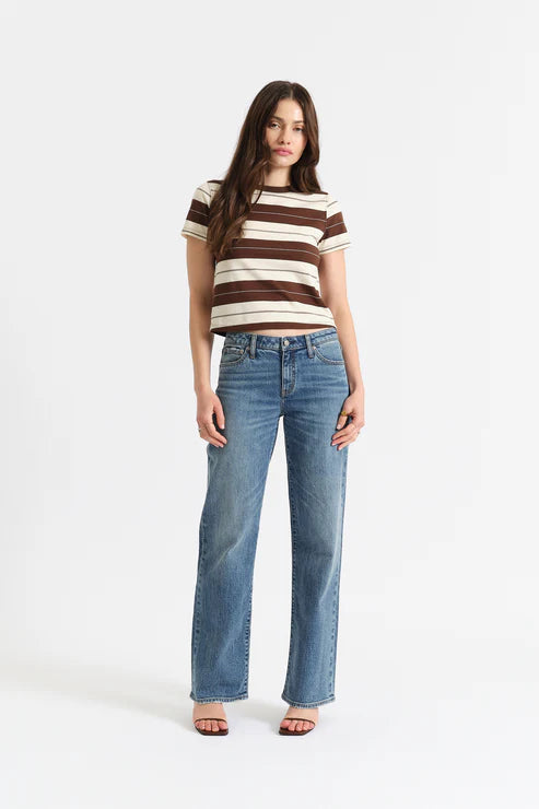 Woman wearing a striped shirt and blue jeans on a white background