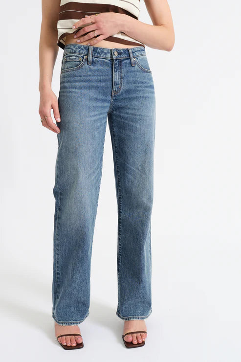 Person wearing blue jeans on a white background