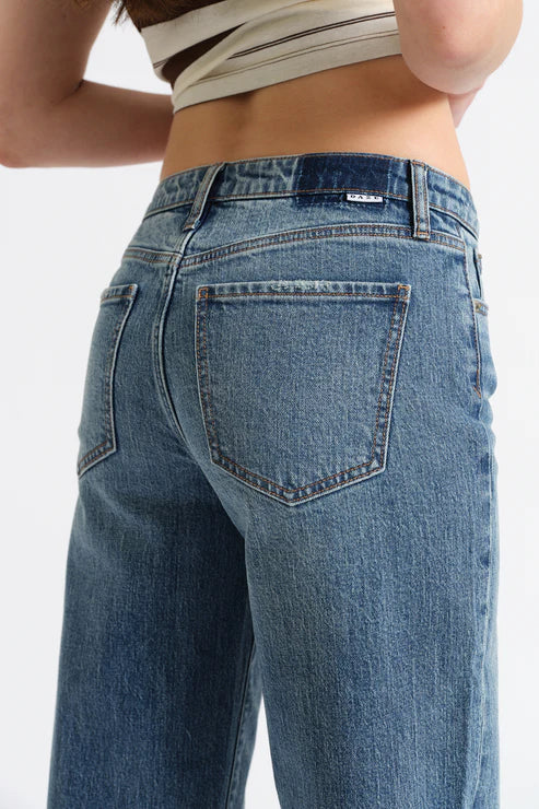 Close-up of blue jeans with a white background
