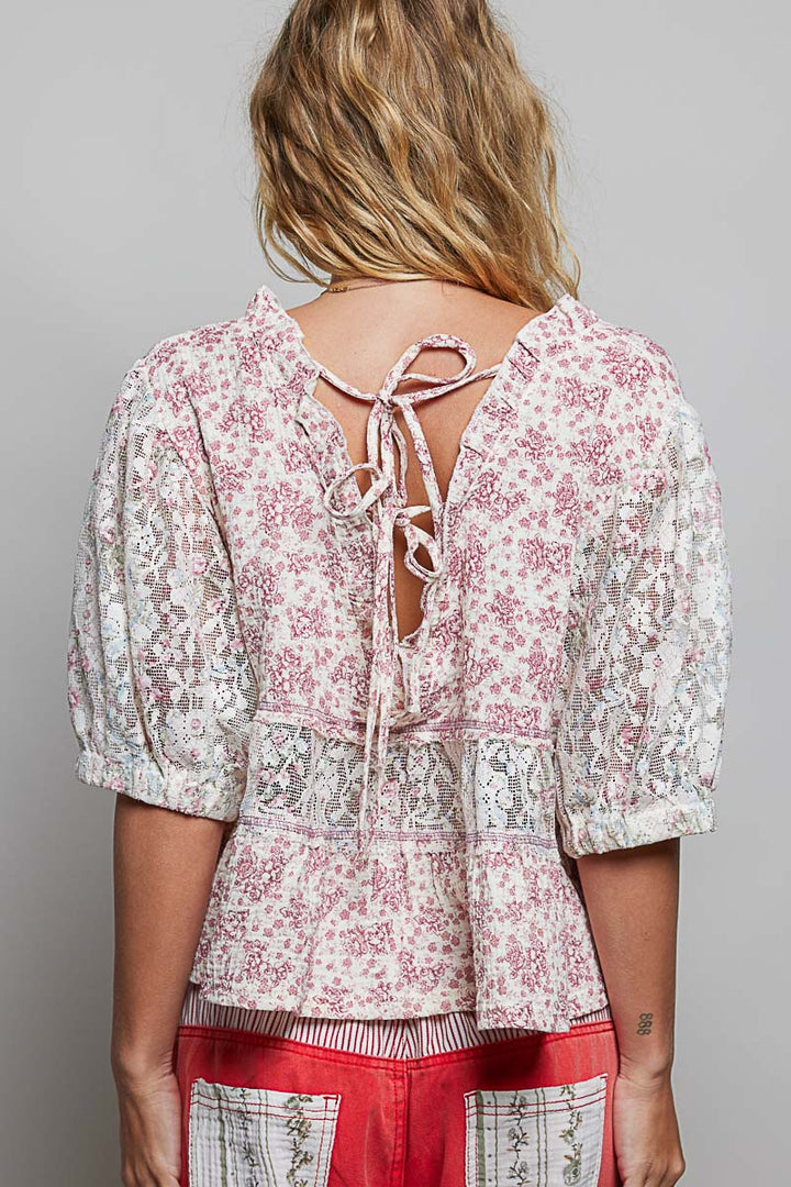 Woman wearing a floral blouse with a gray background