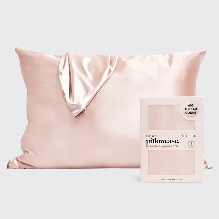 Satin pillowcase on pillow on plain background