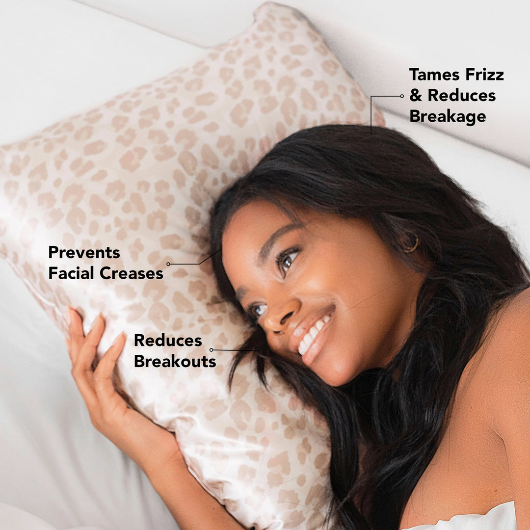 Woman laying on satin pillowcase on pillow with advertising