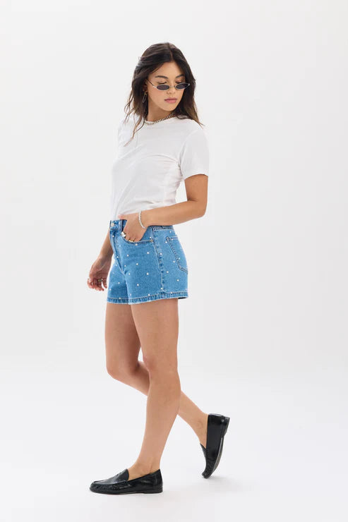Woman wearing a white t-shirt and blue denim skirt on a white background