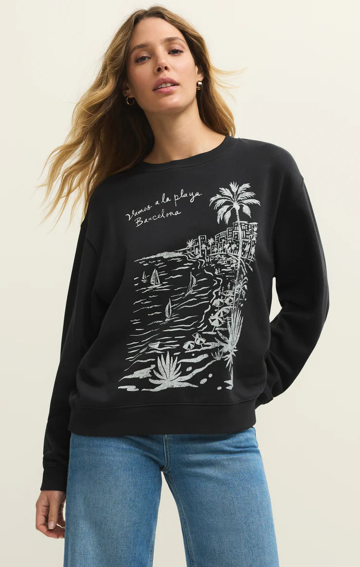Woman wearing a black sweatshirt with a white graphic design on a beige background