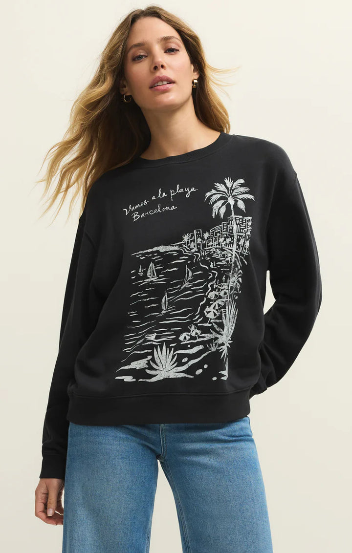 Woman wearing a black sweatshirt with a white graphic design on a beige background