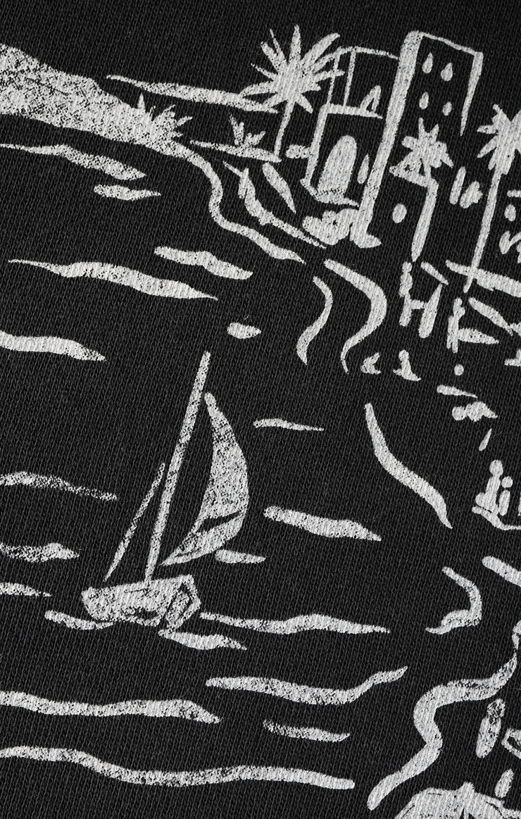 Black fabric with white embroidered design of a sailboat and buildings.