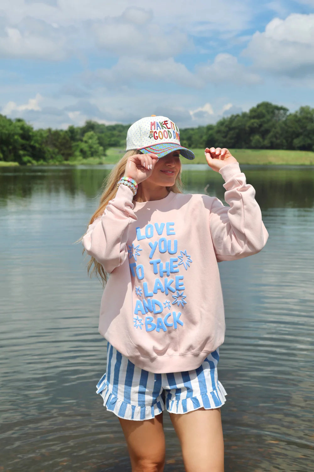 Woman wearing crewneck that says &