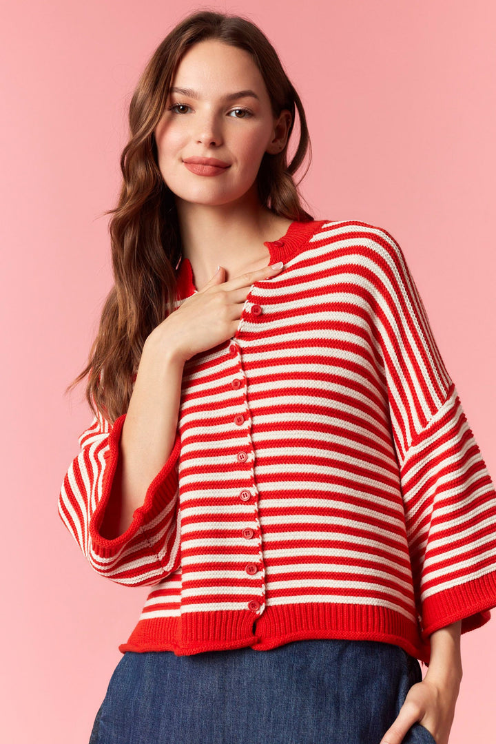 Woman wearing red and white stripe short sleeve cardigan on plain background