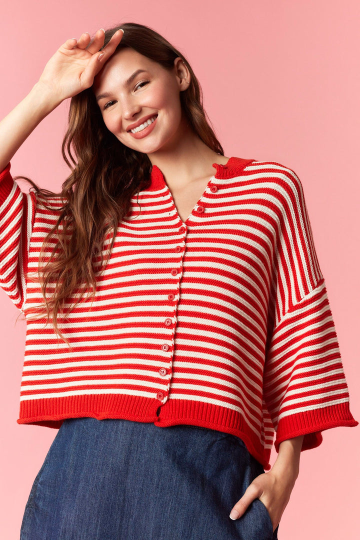 Woman wearing red and white stripe short sleeve cardigan on plain background