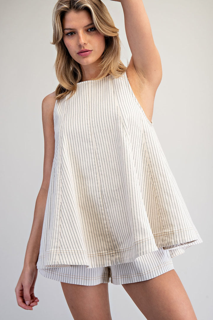 Woman wearing matching stripe set on plain background