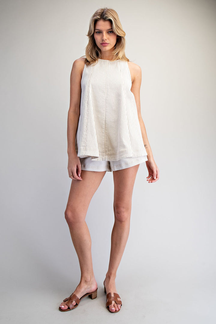 Woman wearing matching stripe set on plain background