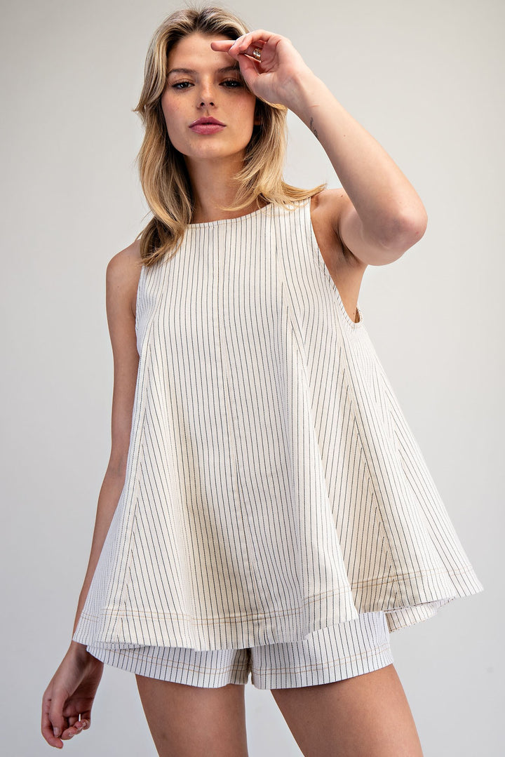 Woman wearing matching stripe set on plain background