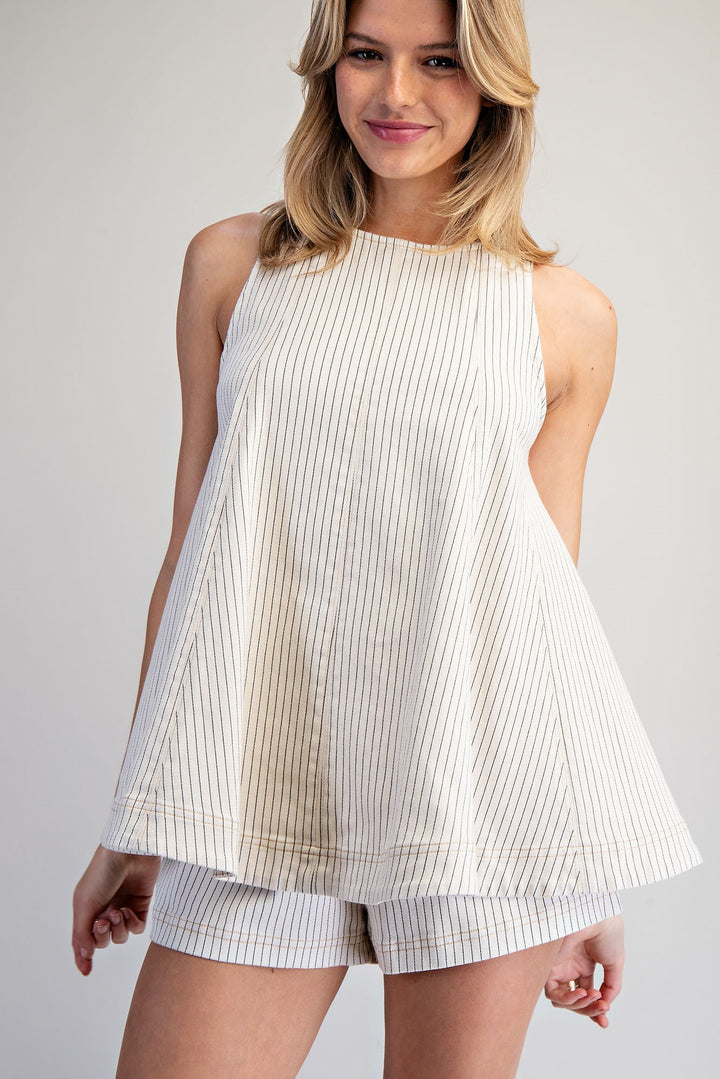 Woman wearing matching stripe set on plain background
