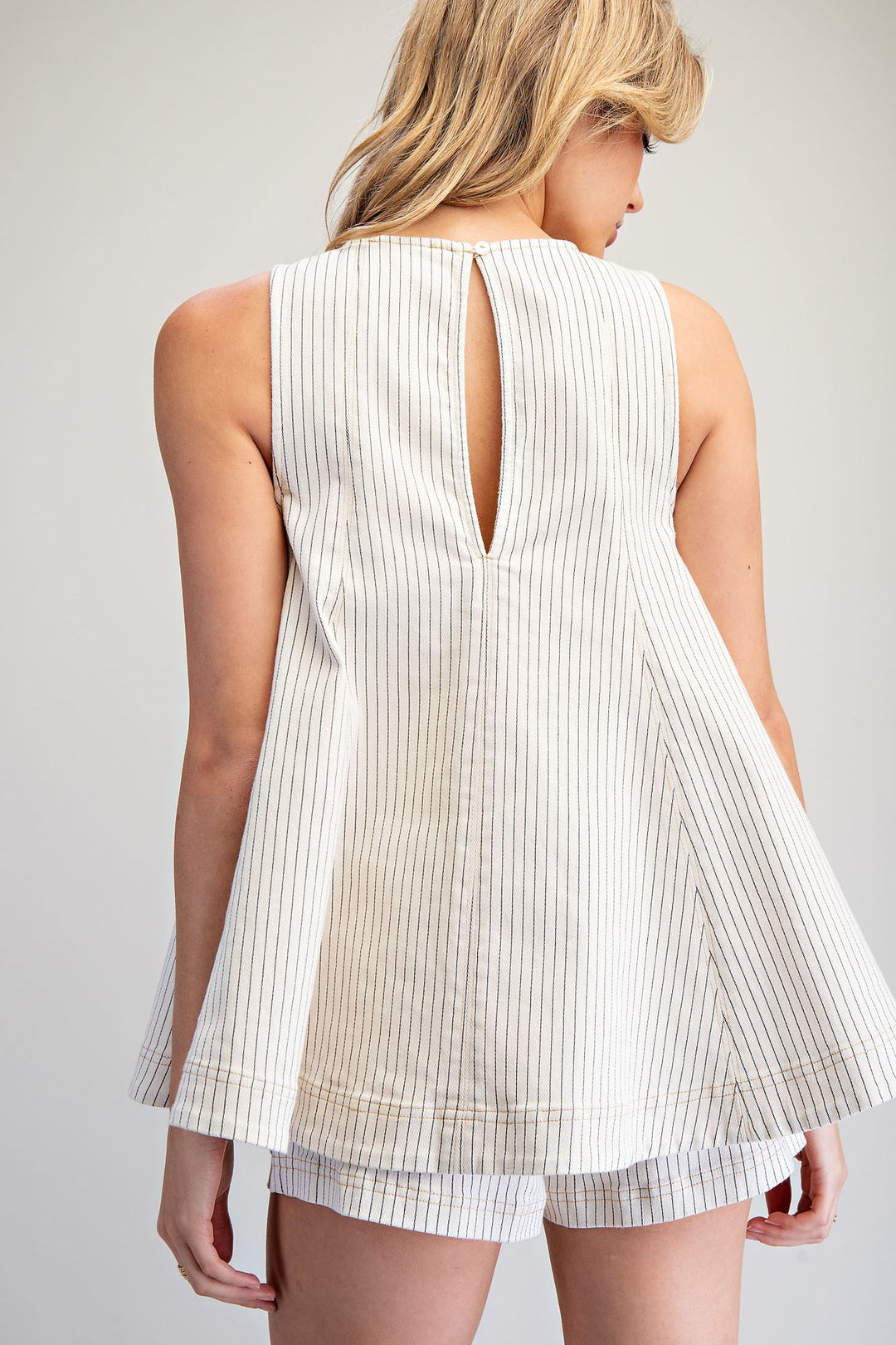 Back of Woman wearing matching stripe set on plain background